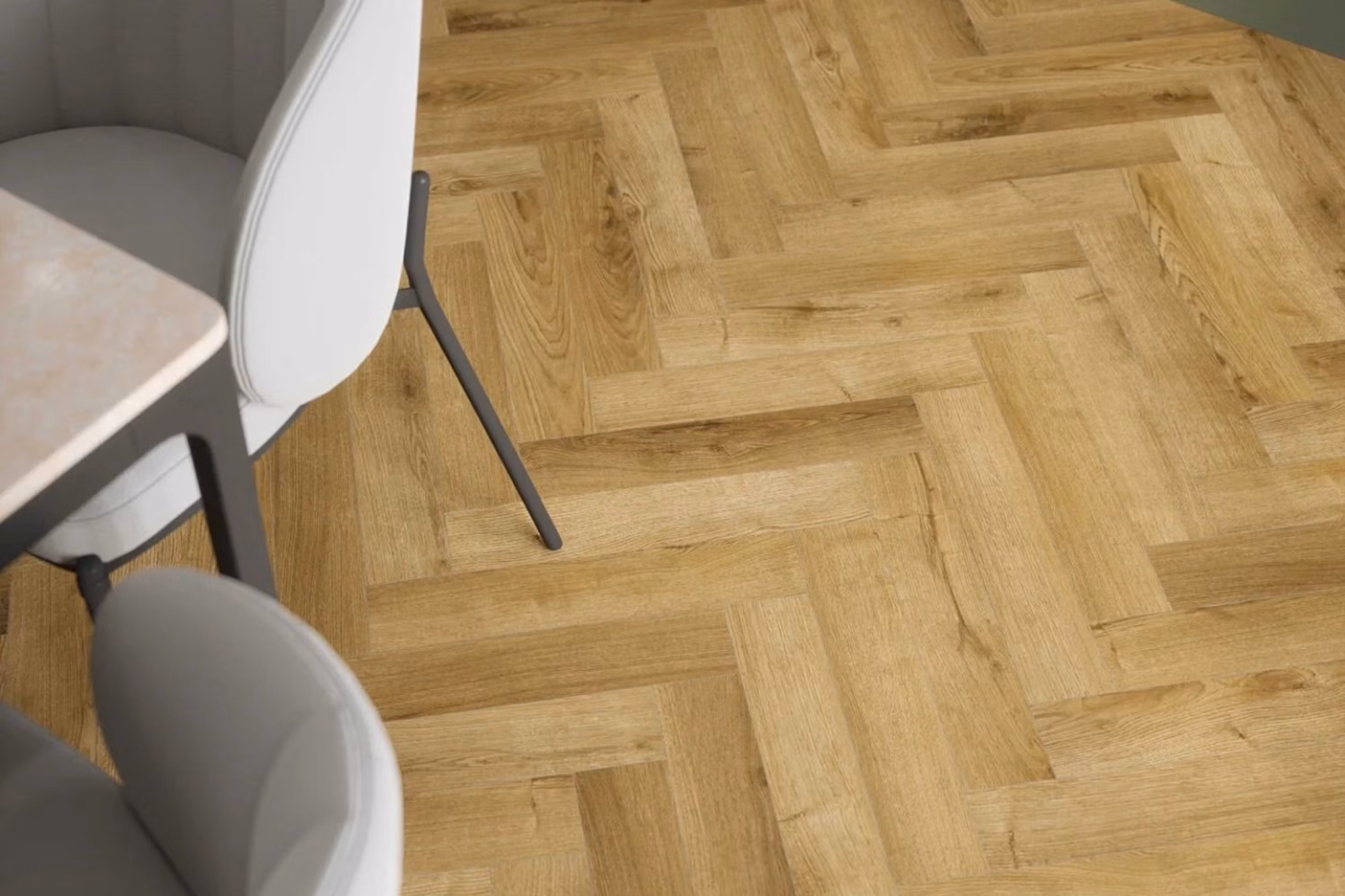 Stade Oak Herringbone laminate flooring shown beneath dining chairs.